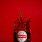 Jar of Umami Hit chili oil with a red background